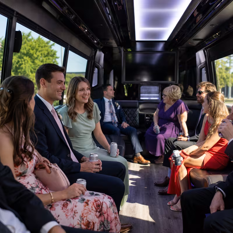 Wedding guests seated inside a Overland Park party bus