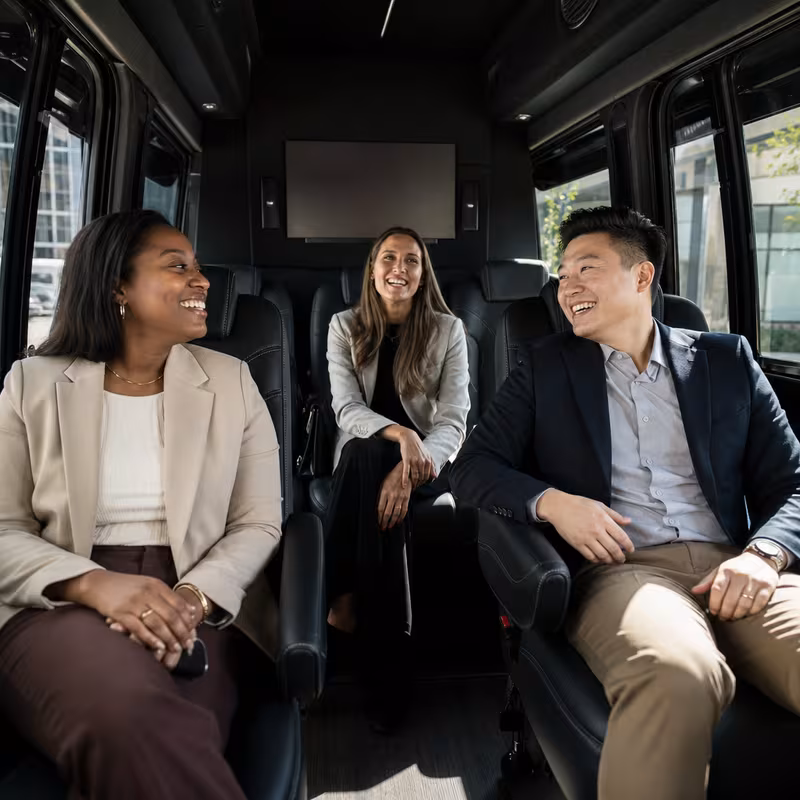 Group boarding a white charter bus for Corporate Transportation transportation in Overland Park