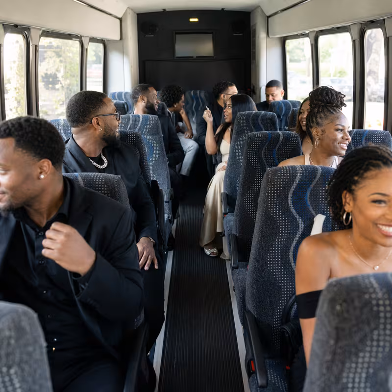 Group boarding a white charter bus for Private Event Transportation transportation in Overland Park