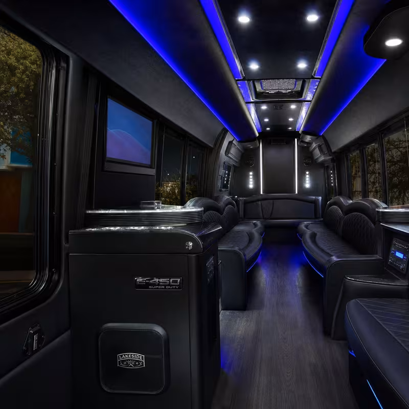Party bus interior with wraparound leather seating and LED lighting in Overland Park