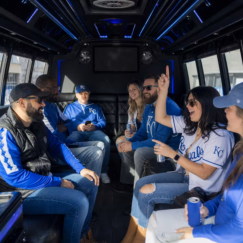Group boarding a white charter bus for Sporting Event Transportation transportation in Overland Park