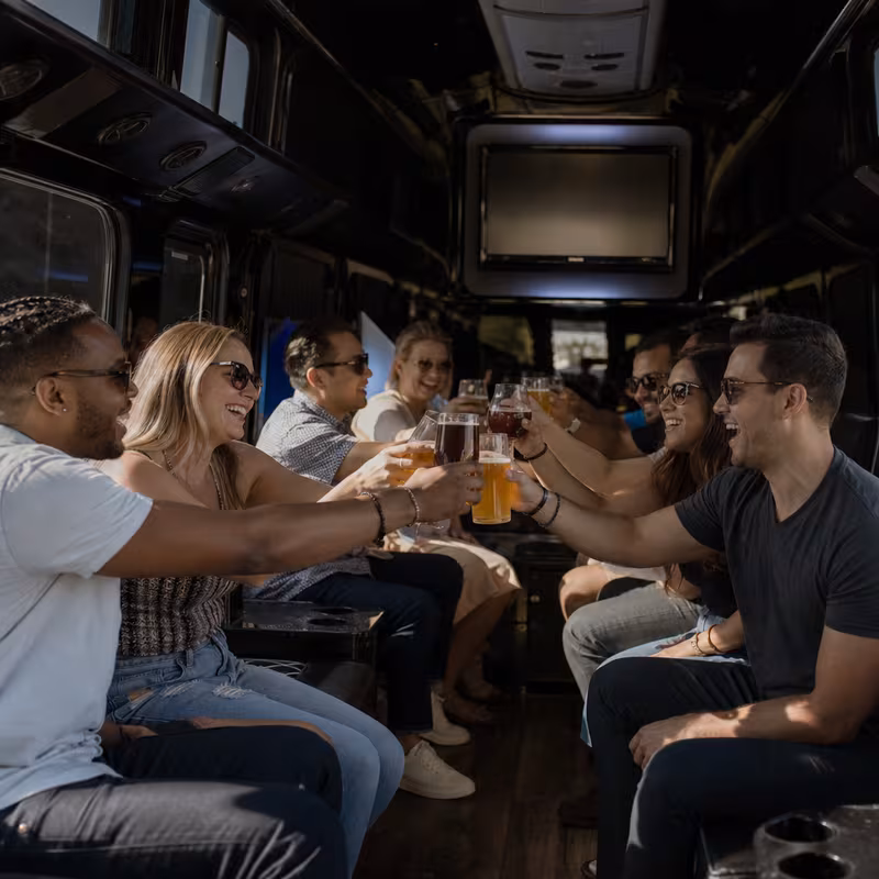 Group boarding a white charter bus for Winery & Brewery Tour Transportation transportation in Overland Park